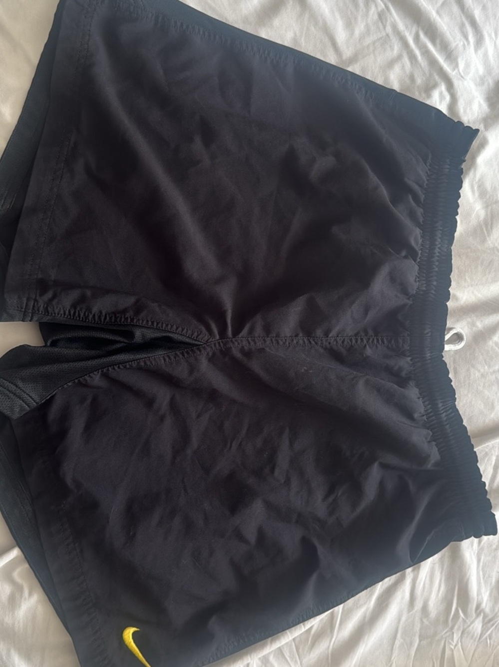 Nike Women’s Black Athletic Shorts with Yellow Swoosh Accent